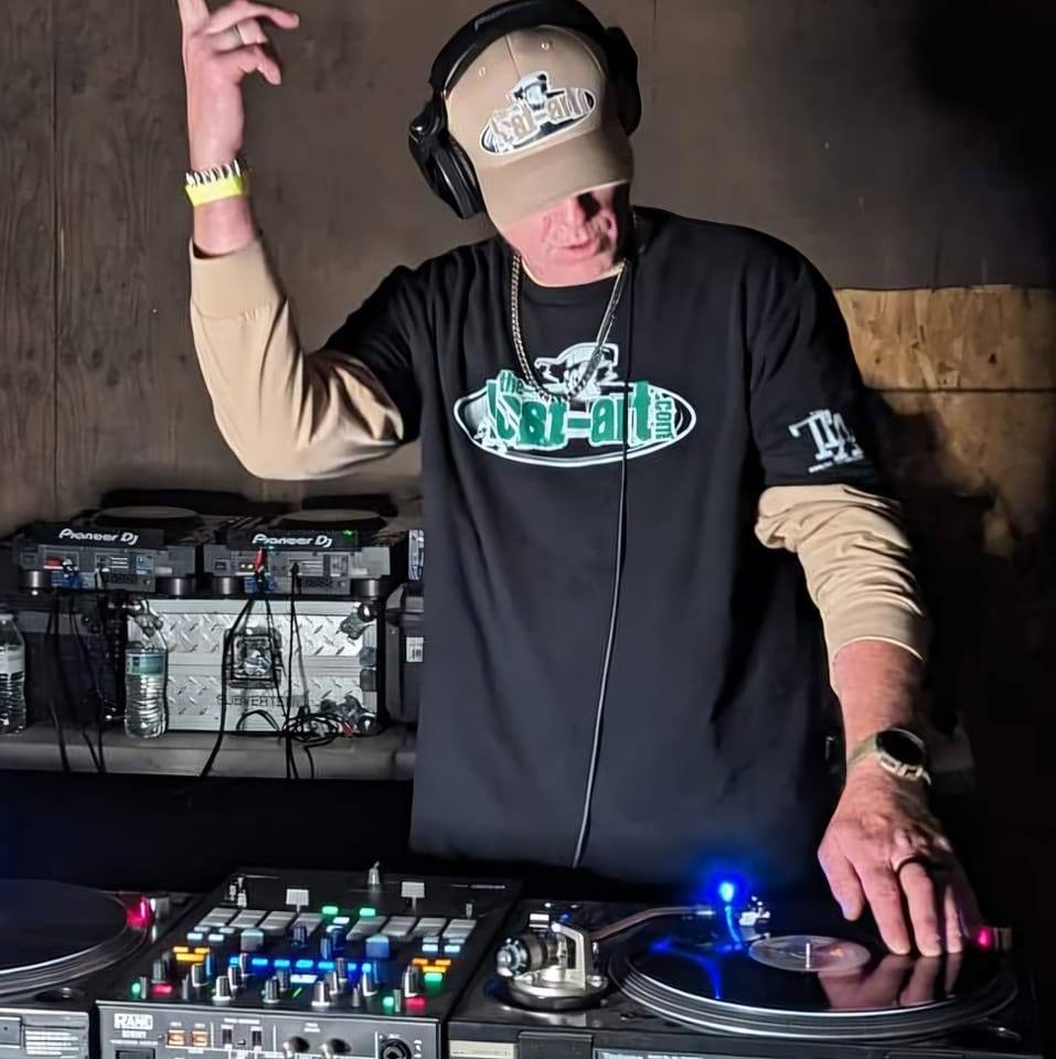 DJ Natural Nate® on Pioneer DJ and Rane mixer in The-Lost-Art.com shirt with hand raised